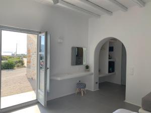 a white room with a sink and a mirror at Thomas Villas on the beach Katapola in Katapola