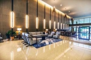 a lobby with couches and tables in a building at Ammoa Luxury Hotel & Spa Resort in Nikiti