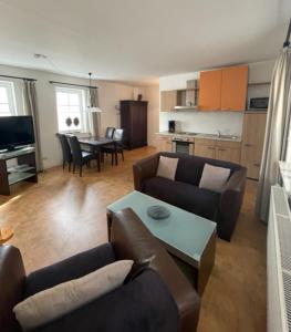 a living room with a couch and a table at Ferienwohnung Keil in Bad Schandau