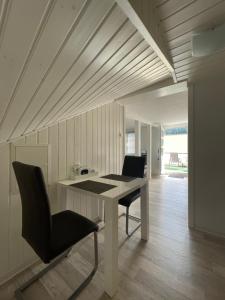 a white table and a chair in a room at Ferienwohnung Keil in Bad Schandau
