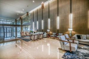 a lobby with couches and chairs in a building at Ammoa Luxury Hotel & Spa Resort in Nikiti