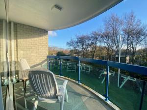 a balcony with two chairs and a table on a balcony at Badhotel 316 in Callantsoog