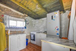 a small kitchen with a refrigerator and a window at House Majka Marija in Tkon +21 photos