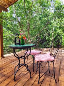 a table and two chairs on a deck at Love Frequency - יורט קסום במתת in Mattat