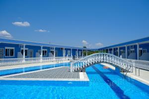 a swimming pool with a bridge in front of a building at Apartment Radosevic in Olympic Beach