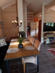 a dining room with a wooden table and chairs at 100m lift, 2 min swim - Large family cabin in Vradal