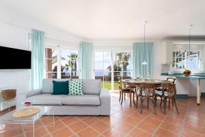 a living room with a couch and a table at Casa Melocoton - Private pool - Ocean View - BBQ - Garden - Terrace - Free Wifi - Child & Pet-Friendly - 4 bedrooms - 8 people in La Listada