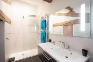 a white bathroom with a shower and a sink at Vandenbeld Wines B&B in Minzac