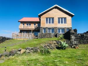 a house on top of a grassy hill at Casa-do-Mar in Madalena