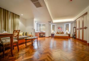 a large living room with a wooden floor and furniture at The Grand Sathorn in Bangkok +37 photos