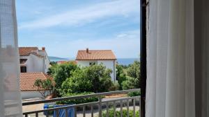 a view from a balcony of buildings and trees at Villa Art House Krk in Krk