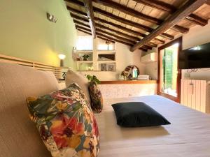 a bedroom with a bed with a black pillow on it at Rooftop Boho Loft Spanish Steps in Rome