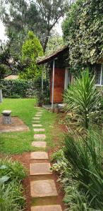 a garden with a path leading to a house at VESA Guesthouse in Meyerton