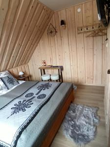 a bedroom with a bed in a wooden room at VILLA JAGODOVO Biały Dunajec in Biały Dunajec