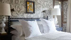 a bedroom with a bed with white pillows at The George In Rye in Rye