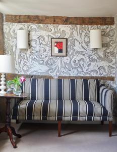 a bench in a living room with a wallpaper at The George In Rye in Rye