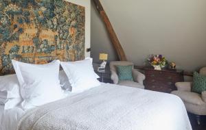 a bedroom with a white bed and two chairs at The George In Rye in Rye