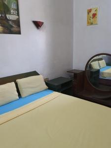 a bedroom with a bed and a desk and a mirror at African House Hostel in Cairo