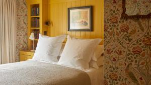 a bedroom with a bed with white pillows at The George In Rye in Rye