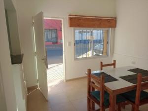 a dining room with a table and a window at CENTENO CASI 9 DE JULIO in Santa Rosa