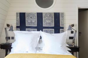a bed with white pillows and a blue and white wall at The George In Rye in Rye
