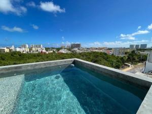 a swimming pool with a view of the city at Mangle By Andiani in Cancún