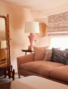 a living room with a couch and a lamp at The George In Rye in Rye