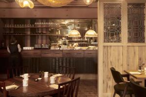 a dining room with a table and a kitchen at The George In Rye in Rye