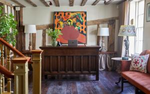 a living room with a table with a laptop on it at The George In Rye in Rye