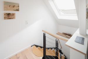 - un escalier dans une maison avec une lucarne dans l'établissement Haus Salz&Sand Lüttje Tide, à Norderney