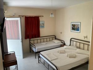 Postel nebo postele na pokoji v ubytování Polyxenis Rooms