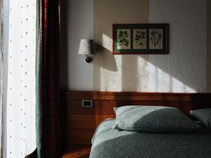 เตียงในห้องที่ Hotel Walser Courmayeur