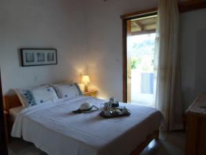 a bedroom with a bed with a tray of food on it at Bozelia Apartments in Toroni