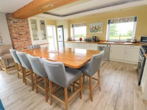 a kitchen and dining room with a wooden table and chairs at Landfall in Warren