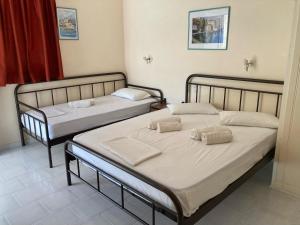Postel nebo postele na pokoji v ubytování Polyxenis Rooms