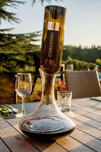 a wine glass sitting on a table with two wine glasses at Vandenbeld Wines B&B in Minzac