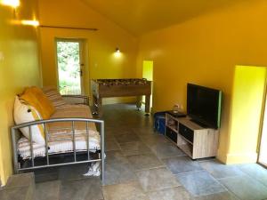 Televízia a/alebo spoločenská miestnosť v ubytovaní merveilleux cottage dans parc de 7,5 hectares