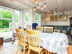 a dining room with a table and chairs at 5 person holiday home in Hemmet in Hemmet