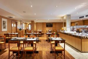 a restaurant with tables and chairs and a bar at Windsor Copa Hotel in Rio de Janeiro