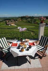 a table with food on it with two chairs at AGRITURISMO CINQUE CAMINI in San Marzano Oliveto