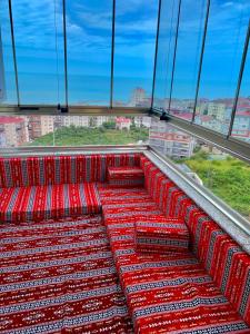 a group of red seats on an observation deck at Shahin Golden Hotel l الصقر الذهبي… in Bostancı