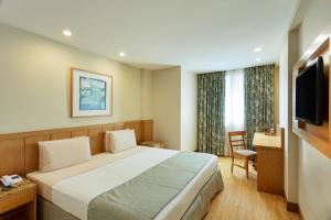 Ένα ή περισσότερα κρεβάτια σε δωμάτιο στο Windsor Copa Hotel