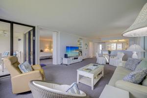 a living room with a couch and chairs and a tv at Loggerhead Cay #112 in Sanibel