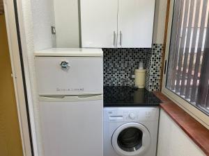 a washer and dryer in a tiny house at Residence _Capo Gallo in Palermo