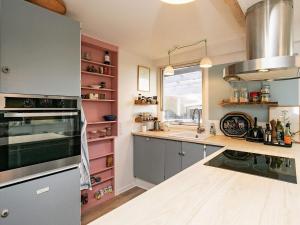 a kitchen with a sink and a stove top oven at 6 person holiday home in Rude in Rude +26 photos