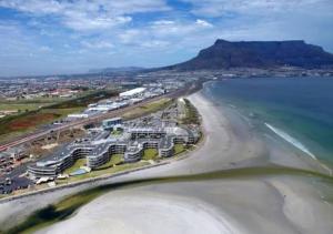 an aerial view of a beach with buildings and the ocean at Pixie Lodge in Cape Town