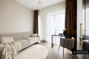 a living room with a couch and a table at Luxury apartment in the city centre in Tallinn