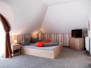 a bedroom with a bed and a television in it at Margret Haus in Balatonfüred