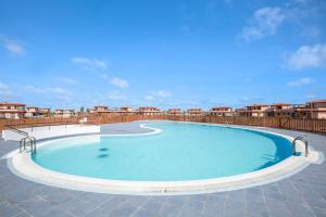 a large swimming pool on top of a building at Sunny Home in Lajares
