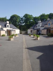 a row of houses in a parking lot at Chez Christine in Ploemel